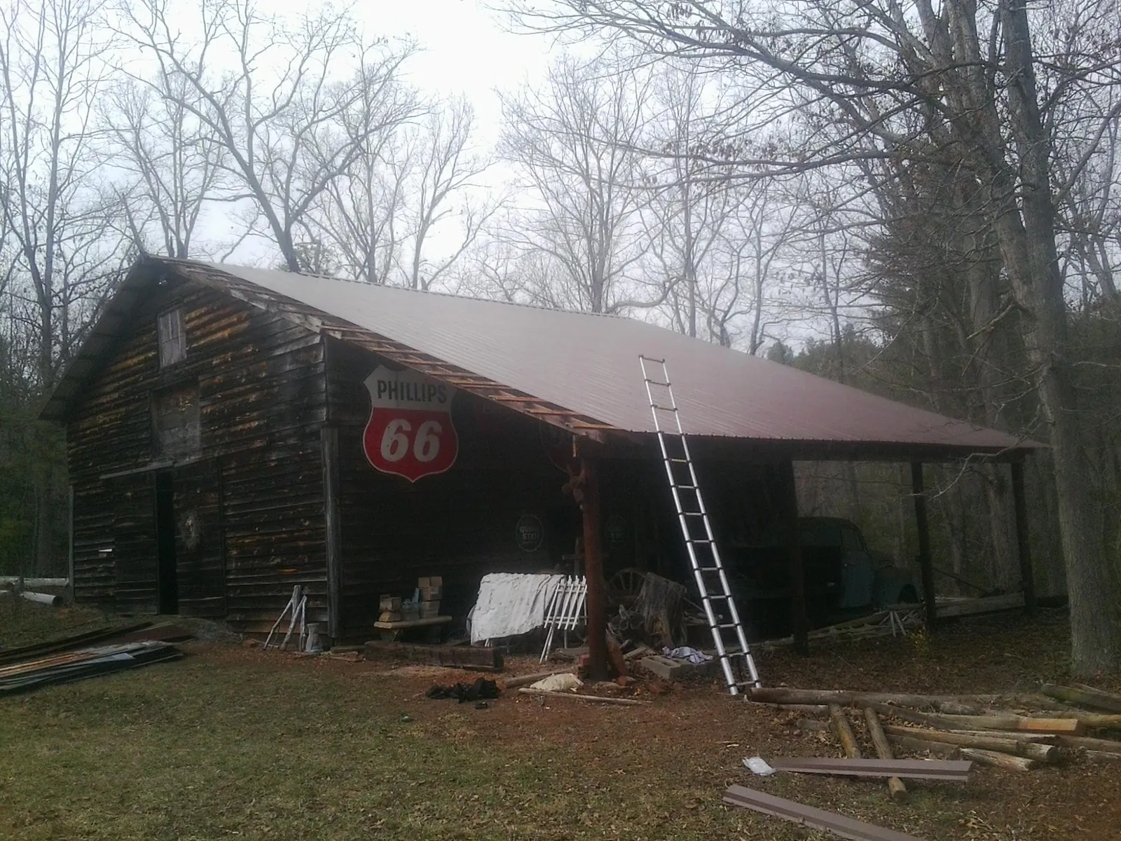 New metal roof on an open sided timber barn with a vintage sign in Laurier